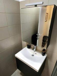 a bathroom with a white sink and a mirror at BRUSSELS EXPO APARTMENT in Brussels