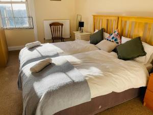 a bedroom with a large bed with pillows on it at 22B in Wellingborough