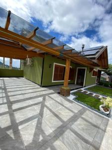 a house with a glass roof and a patio at Casa Petri Gramado in Gramado