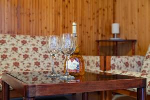 a table with two glasses and a bottle of wine at Sunny Clara Önálló Nyaraló in Siófok +12 photos