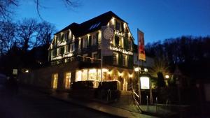 a large building with lights on it at night at Hotel Henriette Davidis in Wetter