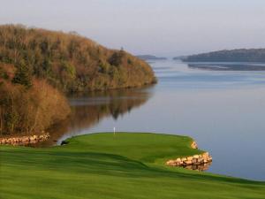 a golf course next to a large body of water at Dovecote Lodge on the 5 star Lough Erne Resort in Ballycassidy