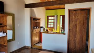 a kitchen with a white refrigerator in a room at Chales Quinteto de Cores in Lavras Novas