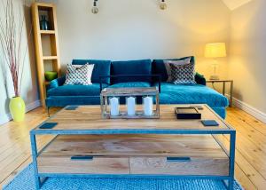 a living room with a blue couch and a coffee table at 16 St Martins near to Steep Hill in Lincoln