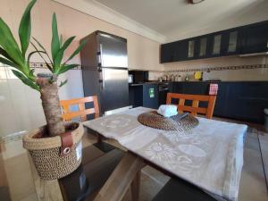 a kitchen with a table and a potted plant at Segredos da Montanha - Seia in Seia