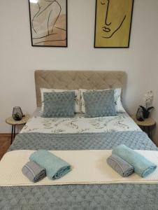 a bedroom with a large bed with two pillows on it at Stan na dan Zvornik in Zvornik