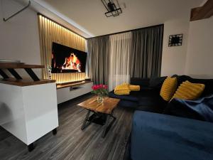 a living room with a couch and a fireplace at Apartmán PiccolaDuo v Banskej Bystrici in Banská Bystrica