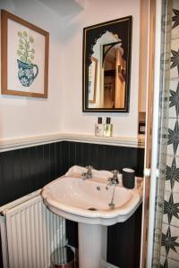 a bathroom with a sink and a mirror at The Folly in Sedbergh