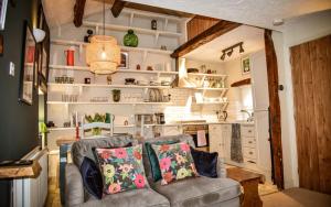 a living room with a couch and a kitchen at The Folly in Sedbergh