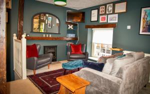 a living room with a couch and a fireplace at The Folly in Sedbergh