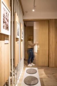 a person standing in a hallway with a door at Heritage & Tales: Sihna in Litochoro
