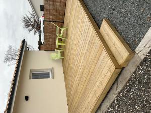 an overhead view of a wooden garage door with a green ladder at Charmant logement neuf in Hourtin