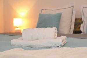 a stack of towels sitting on top of a bed at Apartmán Ivka in Brezno