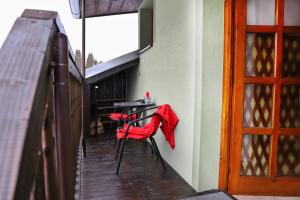 a red umbrella sitting on a table on a patio at Apartmán Ivka in Brezno +42 photos