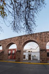 a brick wall with an archway in front of a building at Hotel Boutique Casa San Diego in Morelia