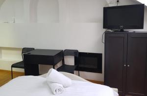 a bedroom with a bed and a tv on a cabinet at Studio Buget Arena Nationala Mega Mall Monza in Bucharest