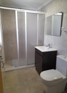 a bathroom with a toilet and a sink and a shower at Casa Elizabeth in Pedrógão Grande