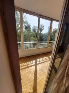 an open door to a room with a view of a balcony at Room 2 in Cairo