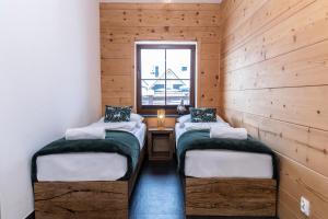 two twin beds in a room with a window at APARTAMENT No 2 MOUNTAIN VIEV Sauna Priv z ogrodem okolice Zakopane Czorsztyn Kluszkowce in Kluszkowce