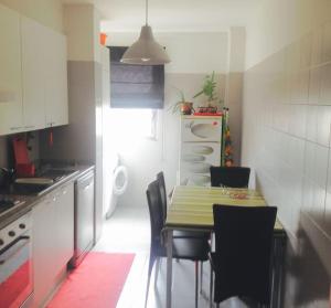 a small kitchen with a table and chairs in it at Luxury Lisbon Apartment. With Air Con. in Lisbon