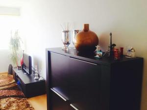 a black entertainment center with a large screen television at Luxury Lisbon Apartment. With Air Con. in Lisbon