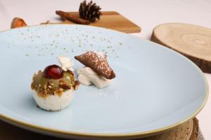 a white plate with a dessert on a table at Hotel Lingemann in Wallenhorst
