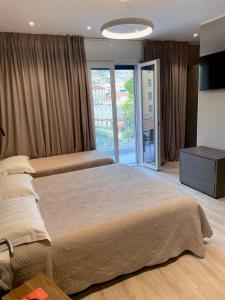 Кровать или кровати в номере Hotel Graziella