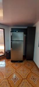 a kitchen with a stainless steel refrigerator in a room at Refugio Sereno en Cartago B&B in Cartago