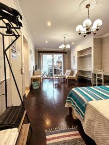 a hotel room with a bed and a living room at Matriz Guest House in Ribeira Grande