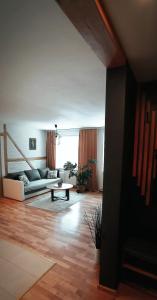 a living room with a couch and a table at Apartament u Edka przy Dolnej II in Świeradów-Zdrój