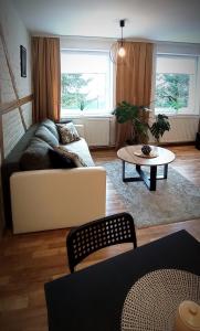 a living room with a couch and a table at Apartament u Edka przy Dolnej II in Świeradów-Zdrój