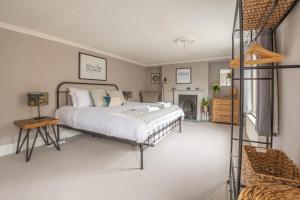 a bedroom with a large bed and a fireplace at The Broadstairs Townhouse in Broadstairs