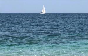 a sail boat in the middle of the ocean at Lovely Apartment In Marina Di Strongoli With House Sea View in Marina di Strongoli