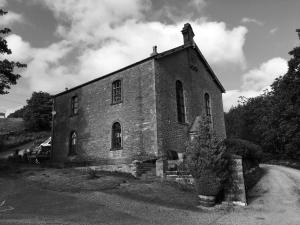 a black and white photo of an old brick building at Beldy Chapel Ground floor apartment in Alston