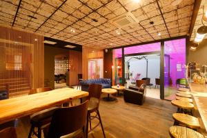 a restaurant with a table and chairs and a room at Hôtel La Fabrique in La Rochelle