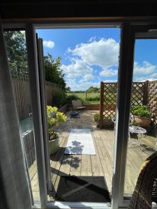 a view of a patio from a sliding glass door at The Log Cabin in Wimborne Minster