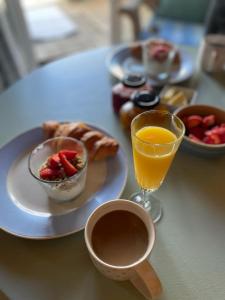 a table with a plate of food and a glass of orange juice at The Log Cabin in Wimborne Minster