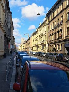 a row of parked cars on a city street at The Nook Apartment in Zagreb
