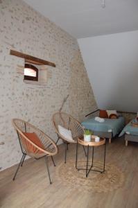 a living room with two chairs and a couch at Sophie LE FEUVRE - Soins Energétiques in Baugé-en-Anjou