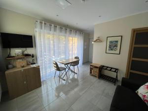 盧河畔圖爾雷泰的住宿－Appartement au calme dans un espace arboré，客厅配有桌椅和电视。