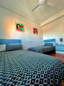 a bedroom with two beds and a ceiling fan at Apartamento La Zahora - Alcañiz in Alcañiz +18 photos