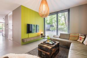 a living room with a couch and a tv at Villa Merici in Bergen