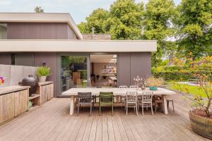 a patio with a table and chairs on a deck at Villa Merici in Bergen