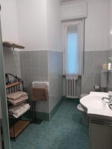 une salle de bain avec un lavabo et des toilettes et une fenêtre dans l'établissement PRIMO PIANO - Bilocale Casa Vacanze Brescia, à Brescia