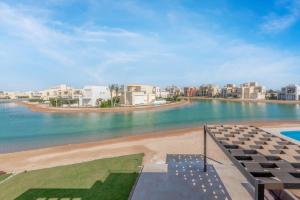 a view of a beach with buildings and the water at Brand-New Family House in Tawila El Gouna Lagoon and Pool Access in Hurghada