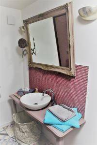 a bathroom with a sink and a mirror at Fairytale Memories SPAS Privatifs in Varsberg