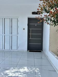 a black garage door on a white wall at (L.I.H.8) Luxury Industrial House 8 in Nea Paphos