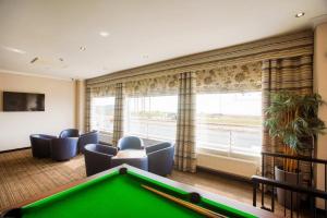 a billiard room with a pool table and chairs at Craig-y-Don in Blackpool