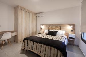 a bedroom with a large bed in a room at Chacras Wineland Lodge - Casa West in Ciudad Lujan de Cuyo +23 photos