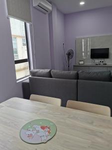 a dining room with a table and a couch at MersingFirstFloor丰盛港二楼民宿 in Mersing